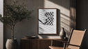 Hand waving checkered racing flag poster framed above a fluted sideboard beside an olive tree