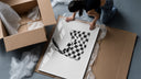 Hand waving checkered racing flag framed print being unpacked from protective bubble wrap and a box