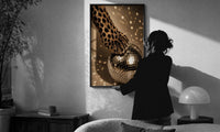 Cheetah Paw and Disco Ball print in a slim black frame being hung on a sunlit wall in a monochrome room