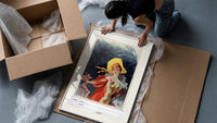 Elegant woman in yellow hat framed print being unpacked from protective bubble wrap and a box