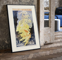 Woman dancing in flames print in a black frame leaning beside a vintage door on parquet