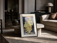 Woman dancing in flames print in a black frame leaning on a travertine table in a sunlit lounge