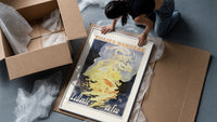 Woman dancing in flames framed print being unpacked from protective bubble wrap and a box