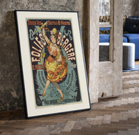 Dancing woman on trapeze print in a black frame leaning beside a vintage door on parquet