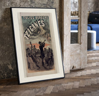 Gypsy musicians playing violin print in a black frame leaning beside a vintage door on parquet