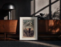 Black-framed Gypsy musicians playing violin print on a moody console with designer coffee-table books