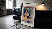 Elegant woman in yellow dress print in a slim black frame leaning on a dark sofa in a concrete print studio