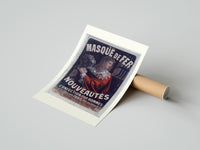 Rolled Man in red cloak holding iron mask poster beside its crush-resistant kraft shipping tube