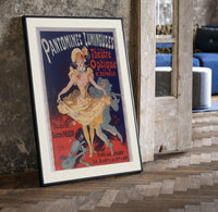 Dancing woman in yellow dress print in a black frame leaning beside a vintage door on parquet