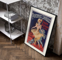 Dancing woman in yellow dress poster in a black frame leaning beside a shelf in a raw-plaster loft