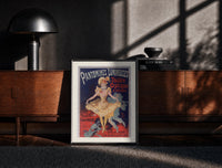 Black-framed Dancing woman in yellow dress print on a moody console with designer coffee-table books