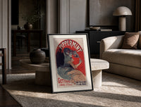 Woman pouring liqueur into glass print in a black frame leaning on a travertine table in a sunlit lounge