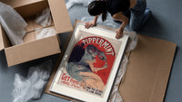 Woman pouring liqueur into glass framed print being unpacked from protective bubble wrap and a box