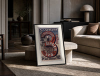 Woman using Singer sewing machine print in a black frame leaning on a travertine table in a sunlit lounge