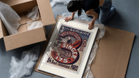 Woman using Singer sewing machine framed print being unpacked from protective bubble wrap and a box