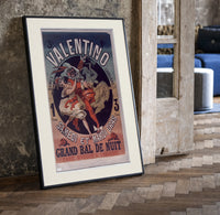 Costumed dancers at masquerade ball print in a black frame leaning beside a vintage door on parquet