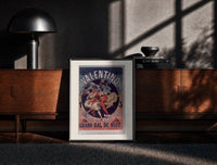 Black-framed Costumed dancers at masquerade ball print on a moody console with designer coffee-table books
