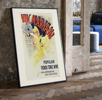 Woman dancing pouring wine print in a black frame leaning beside a vintage door on parquet