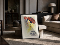 Woman dancing pouring wine print in a black frame leaning on a travertine table in a sunlit lounge