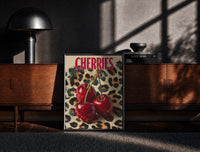 Black-framed Cherries on Leopard print on the floor in front of a dark wooden console