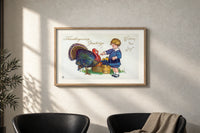 Child and Turkey Wishing You Joy print in an oak frame on a sunlit wall above two leather armchairs