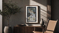 Woman blowing soap bubbles poster framed above a fluted sideboard beside an olive tree