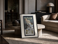 Woman blowing soap bubbles print in a black frame leaning on a travertine table in a sunlit lounge