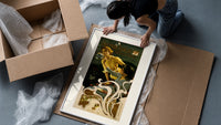 Two women blowing soap bubbles framed print being unpacked from protective bubble wrap and a box
