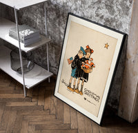 Two children holding Santa doll poster in a black frame leaning beside a shelf in a raw-plaster loft