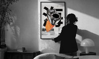 Chrome Salmon Lighter Seafood Market print in a slim black frame being hung on a sunlit wall in a monochrome room