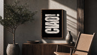 Ciao poster framed above a fluted sideboard beside a potted tree