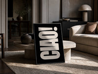 Ciao print on the floor, leaning against a travertine table