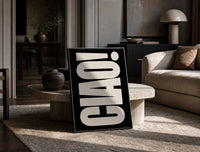 Ciao White on Black print on the floor, leaning against a travertine table