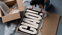 Ciao White on Black framed print being unpacked from protective bubble wrap and a box
