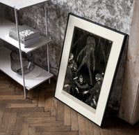 Ghostly figure looming over frightened men poster in a black frame leaning beside a shelf in a raw-plaster loft