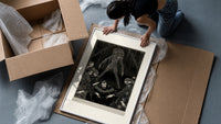 Ghostly figure looming over frightened men framed print being unpacked from protective bubble wrap and a box
