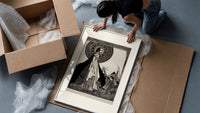 ethereal woman and shrouded man framed print being unpacked from protective bubble wrap and a box