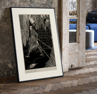 chained man in dungeon catacomb print in a black frame leaning beside a vintage door on parquet