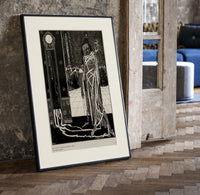 Cloaked skeletal masque figure standing print in a black frame leaning beside a vintage door on parquet
