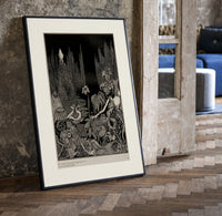 Robed figure atop dark mound print in a black frame leaning beside a vintage door on parquet