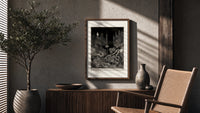 Robed figure atop dark mound poster framed above a fluted sideboard beside an olive tree