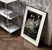 grotesque figures gathered around fantastical scene poster in a black frame leaning beside a shelf in a raw-plaster loft
