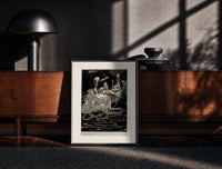 Black-framed grotesque figures gathered around fantastical scene print on a moody console with designer coffee-table books