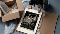 grotesque figures gathered around fantastical scene framed print being unpacked from protective bubble wrap and a box
