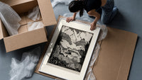 Mountain valley landscape with figure framed print being unpacked from protective bubble wrap and a box