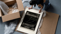 Buried man in coffin underground framed print being unpacked from protective bubble wrap and a box