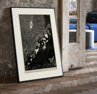 Bound man swarmed by rats print in a black frame leaning beside a vintage door on parquet