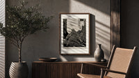 Snarling ape attacking woman poster framed above a fluted sideboard beside an olive tree
