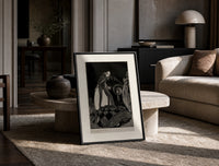 Gaunt sinister man over hidden figure print in a black frame leaning on a travertine table in a sunlit lounge