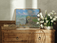 Woman with parasol on cliff print in an oak frame on a farmhouse dresser beside white tulips